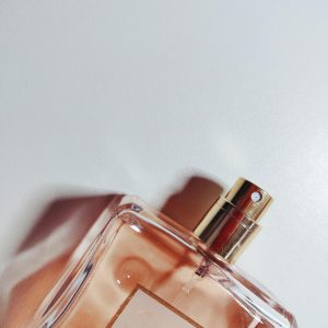 Stylish perfume bottle casting shadows, perfect for lifestyle imagery.